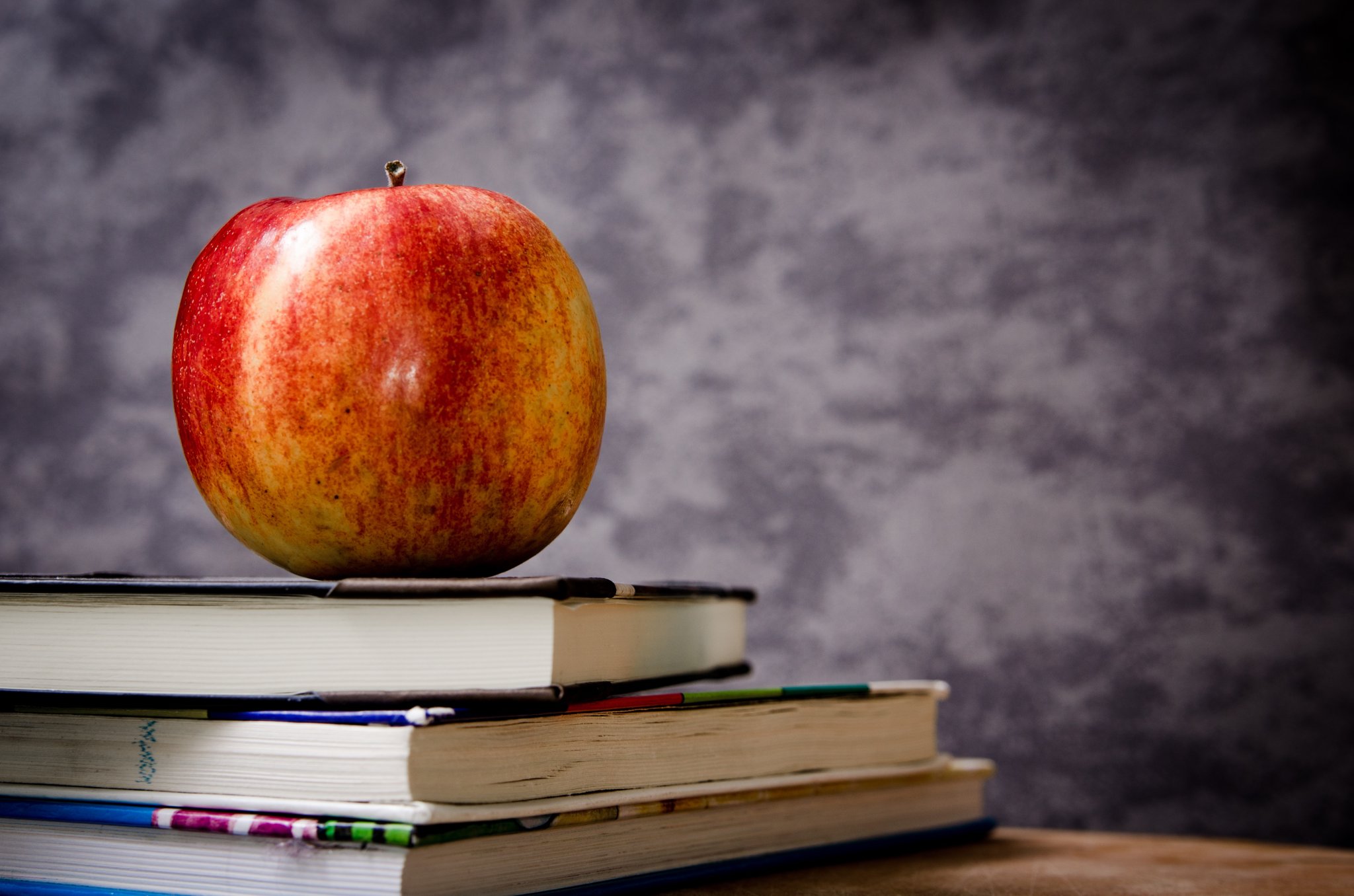 Blackboard with apple on desk